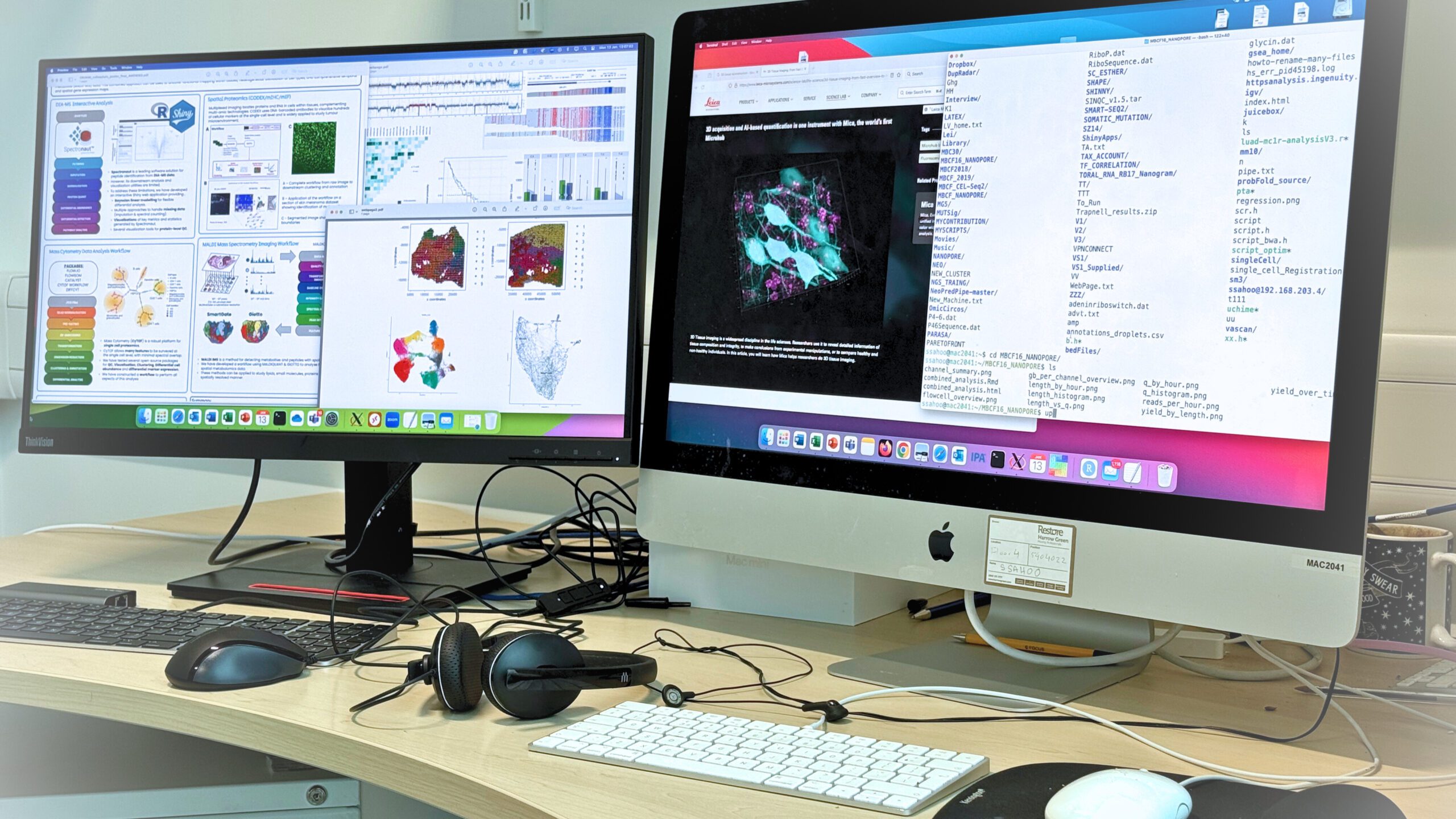 Two computer screens displaying a variety of digital systems and content related to bioinformatics