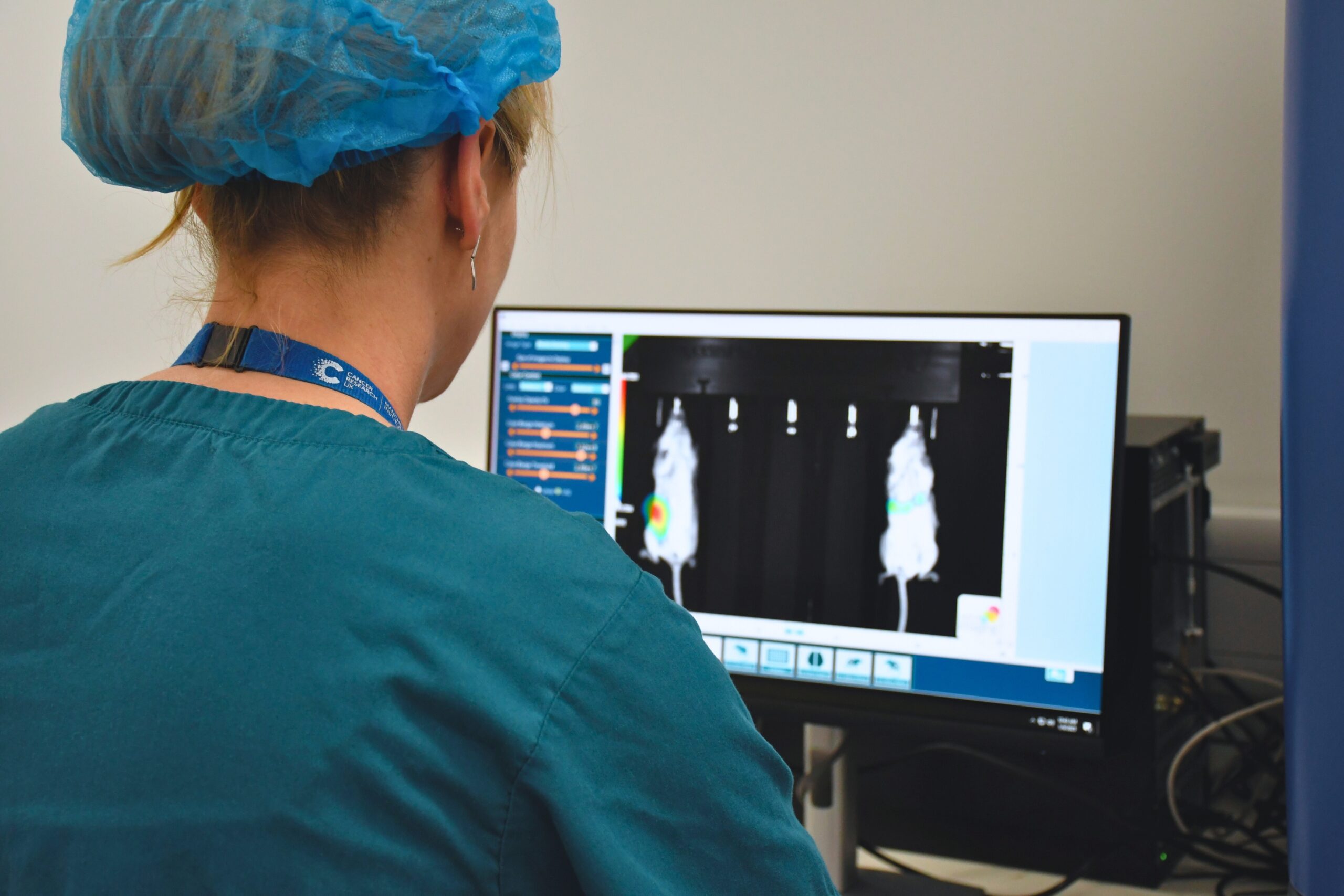 Lisa looking at bioluminiscent markers in mice